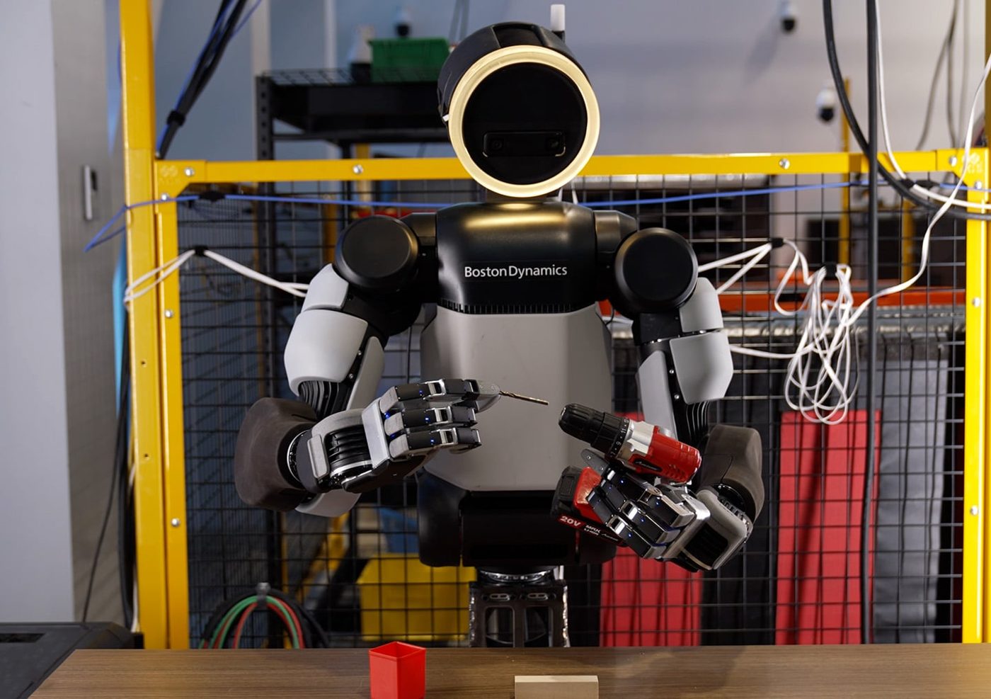 Boston Dynamics Atlas humanoid holding a drill with its new four-finger hand